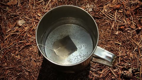 Time lapse of tea bag in boiling water in the woods