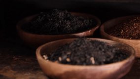Dried loose black tea leaves in wooden bowl