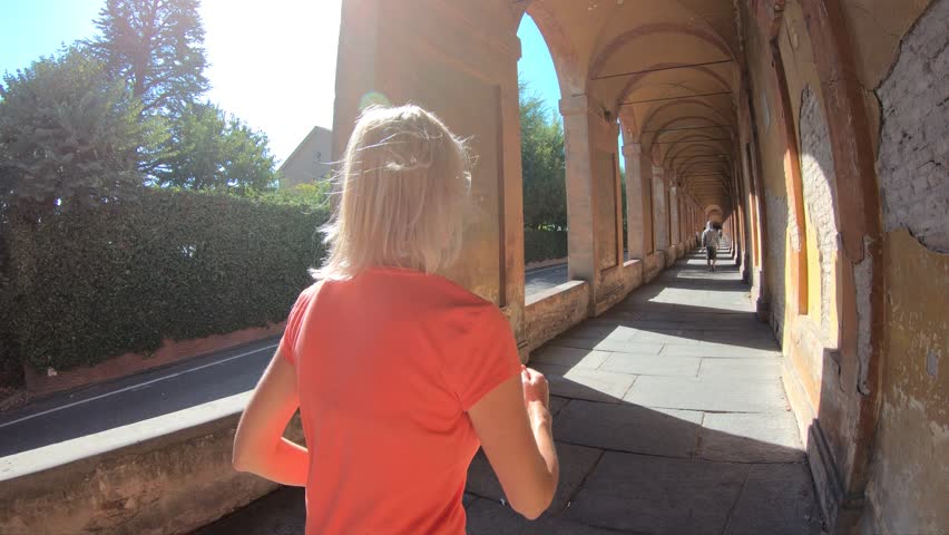 A sportwear woman running under San Luca