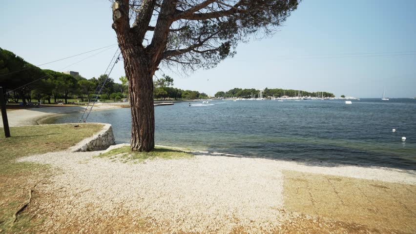 Man wake boarding and performing a jump
