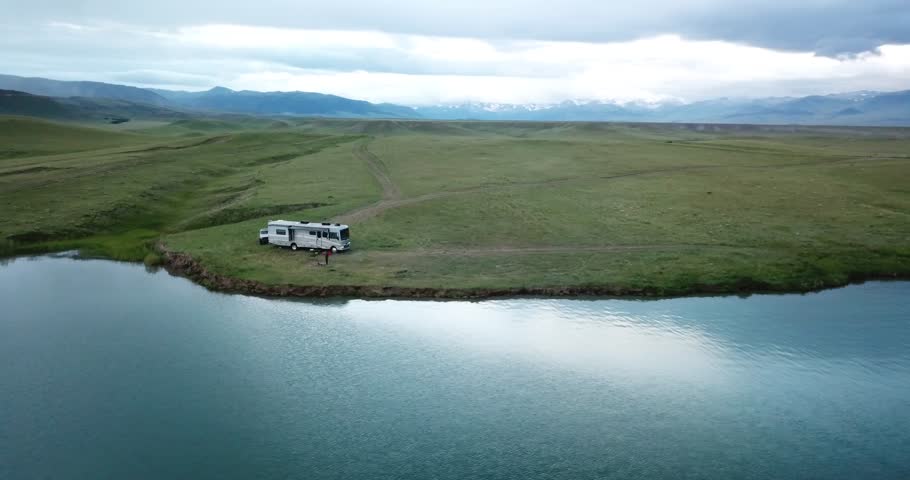 Aerial over lake reservoir remote boondock camping - Wyoming near Yellowstone National Park Royalty-Free Stock Footage #1017365548