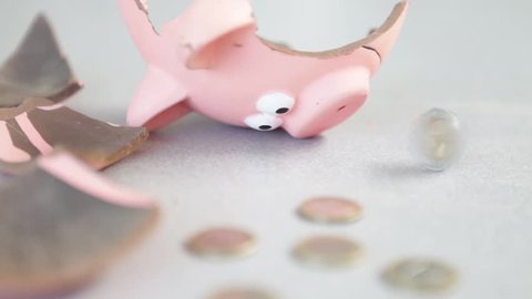 infinite loop, cinemagraph: a coin rotates endlessly near a broken piggy-shaped money bank	