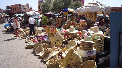 Marrakesh, Morocco - 19th September 2018: Seller with tourist in craft market souk in old town Medina