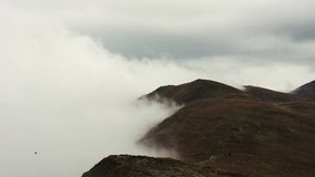 Heavy fog in mountains.Cold autumn weather in Carpathian mountain park.Travel destination for active tourism in Europe.Dramatic clouds in Carpathians.