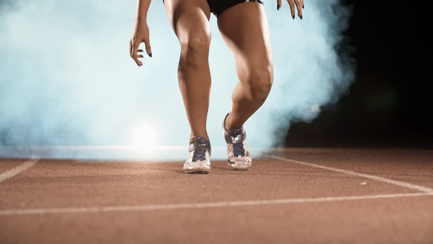 Asian Athlete ready to start. Young female runner preparing for blasting off in mist on sports track of stadium, training before competition 4k Royalty-Free Stock Footage #1017373828