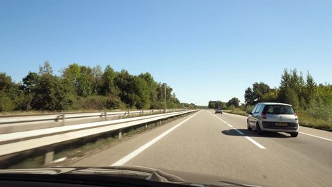 FRANCE - CIRCA 2018: Steadicam shot of car driving on French highway with nearby driving vintage Mercedes-Benz convertible and Renault family van car in the relaxed traffic