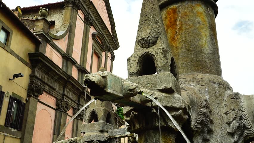 Details of the Grande Fontana in stone with lion-shaped decorations, in a public square in Viterbo