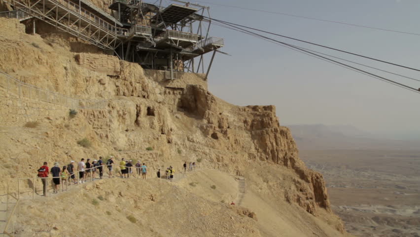 ?able car way at Masada fortress. Tourists walking around.
Masada Cableway. Cable car way to canyon and over the tourists. 