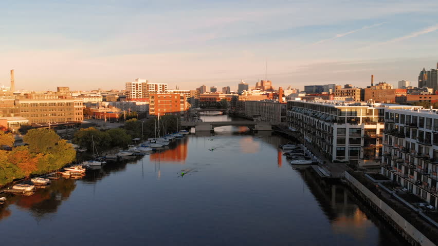 Milwaukee river in downtown, harbor districts of Milwaukee, Wisconsin, United States. Real estate, condos in downtown. Aerial view, drone flying 

