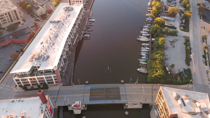 Milwaukee river in downtown, harbor districts of Milwaukee, Wisconsin, United States. Real estate, condos in downtown. Aerial view, drone flying 
