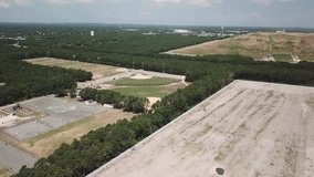 Aerial drone video shutting in Yaphank Long Island with big junk cars parking and Sunrise highway and model airplane park in New York state