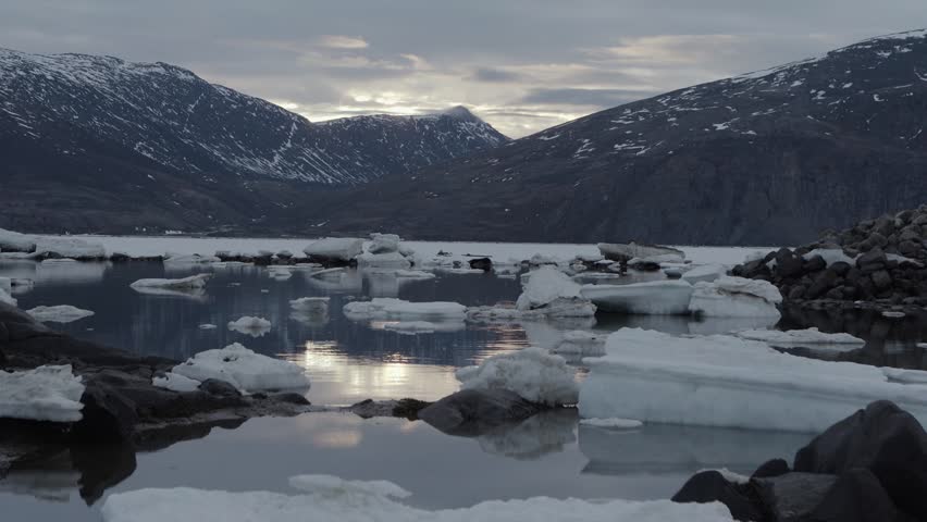 Camera lock off looking toward the mountain on a cloudy day at the beach in Pangnirtung Nunavut.