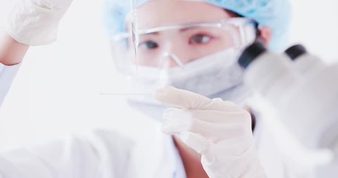 woman scientist take microscope slide in the laboratory