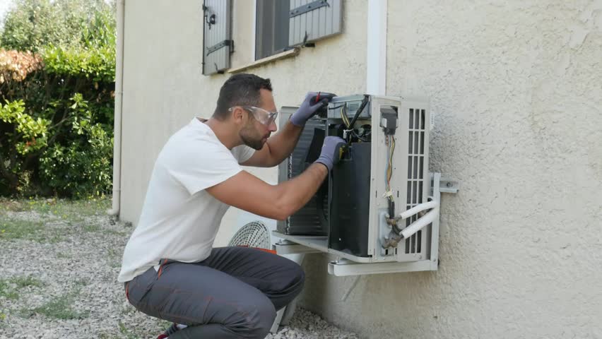 Handsome young man electrician installing air conditioning in a client house
 | Shutterstock HD Video #1017407344