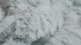 Blue artificial hairy fur blanket details 4K tilting video
