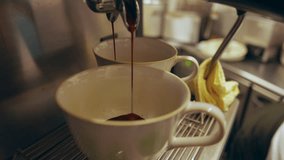 Close up of coffee machine making espresso in white cup