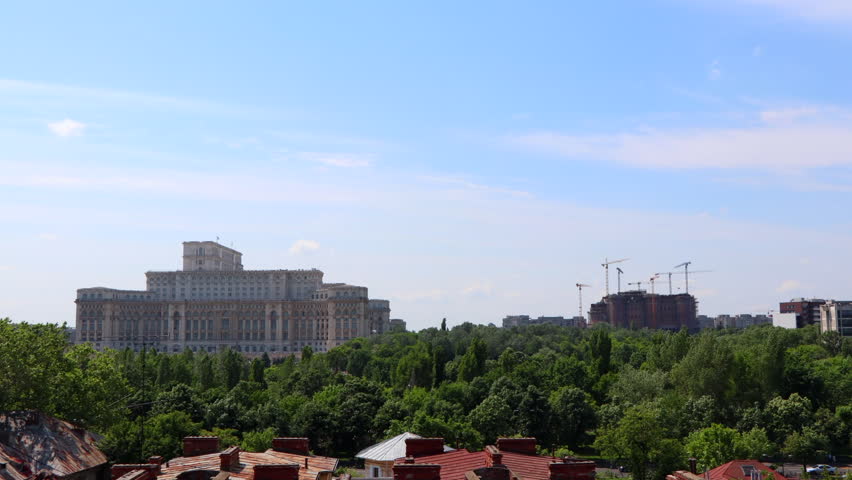 Time Lapse of the Palace of the Parliment in Bucharest, Romania with Construction Cranes Moving in the Background