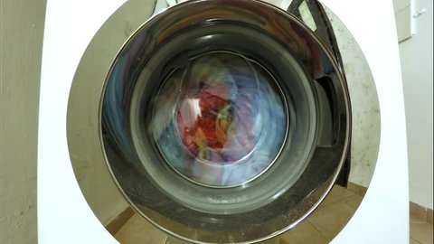 Washing machine doing the laundry with detergent and plenty of water timelapse