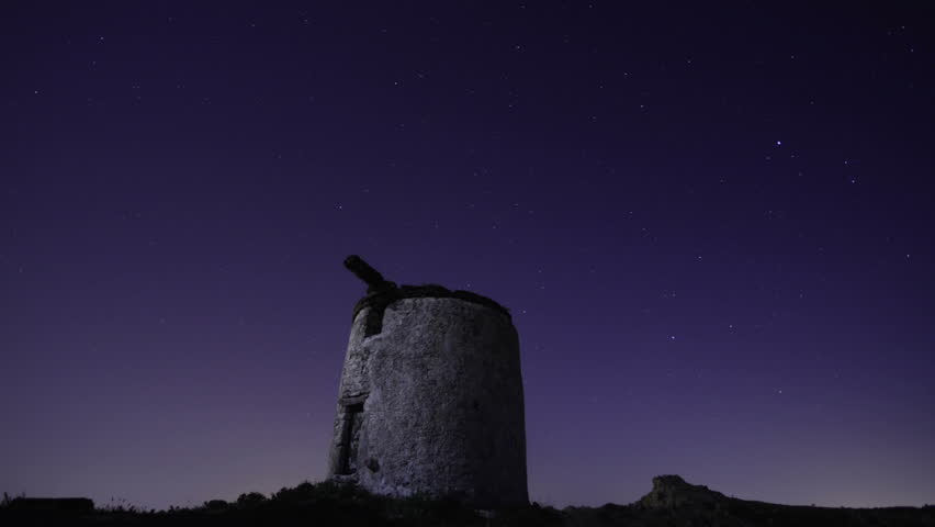an old rundown windmill under the stars