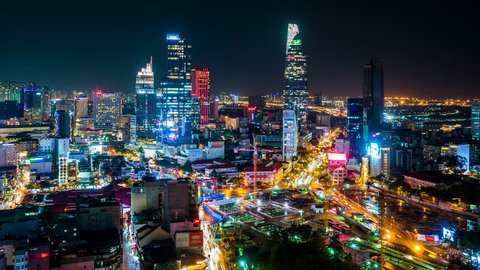 Ho Chi Minh City, Vietnam - June 14, 2018: Time lapse view of Ho Chi Minh City aka Saigon, Vietnam, showing landmark buildings and traffic in the financial district at night. Zoom out.