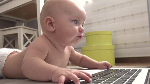 Baby playing with a laptop