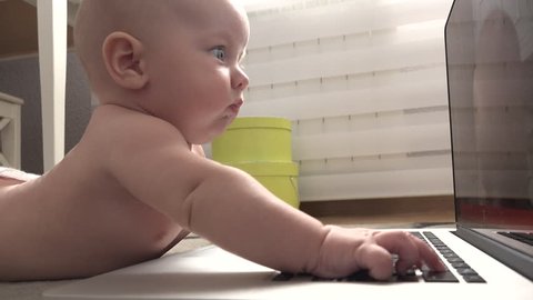 Baby playing with a laptop