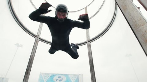 Aerodynamic tube. The wind lifts up the person up and down and spinning around