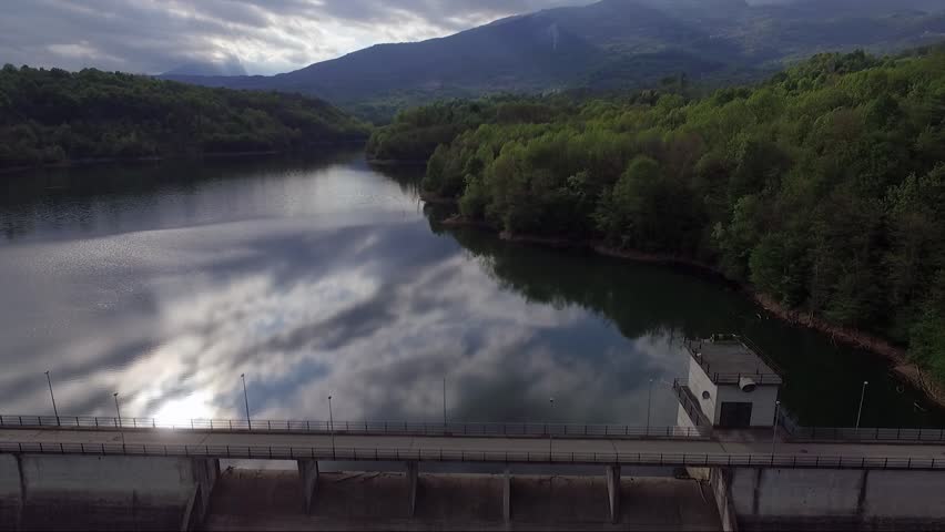 in flight on a dike in Italy in the sunset towards the green hills