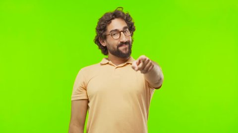 young bearded silly man pointing you against chroma key editable background. ready to cut out the person.
