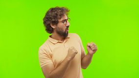 young bearded silly man dancing against chroma key editable background. ready to cut out the person.
