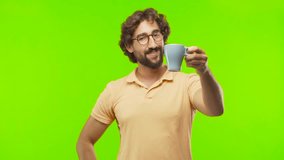 young bearded silly man having a coffee against chroma key editable background. ready to cut out the person.