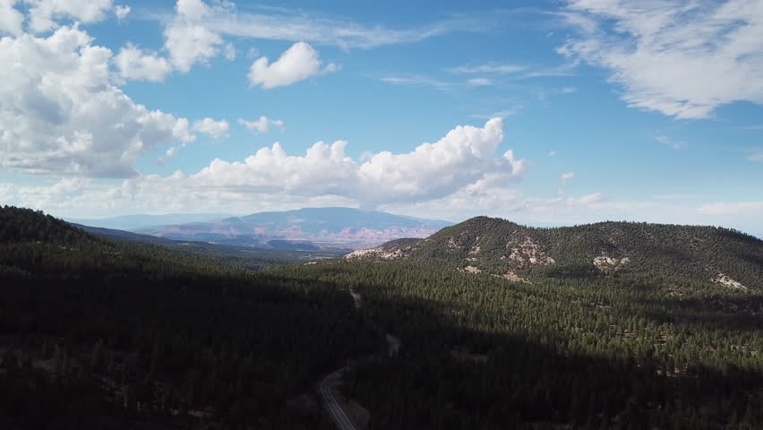 Descending aerial drone shot of forest and mountains in Utah