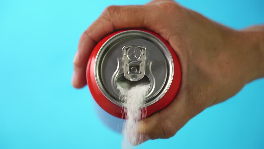 Red soda can pouring out white sugar on a bright blue background showing an example of how bad sugar and how we all eat to much sugar in health food concept. Slow motion  Royalty-Free Stock Footage #1017447364
