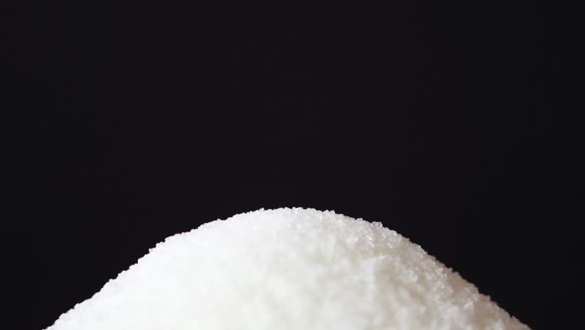 White sugar cube falling off a silver spoon on black background closeup slow motion in diet over eating sugar is bad addiction concept for diabetes | Shutterstock HD Video #1017447799