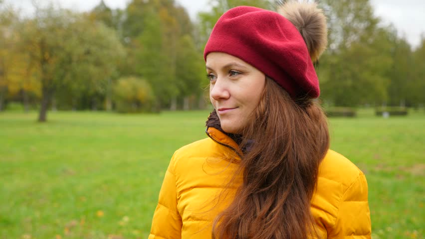Woman portrait in autumn park, funny girl in red beret