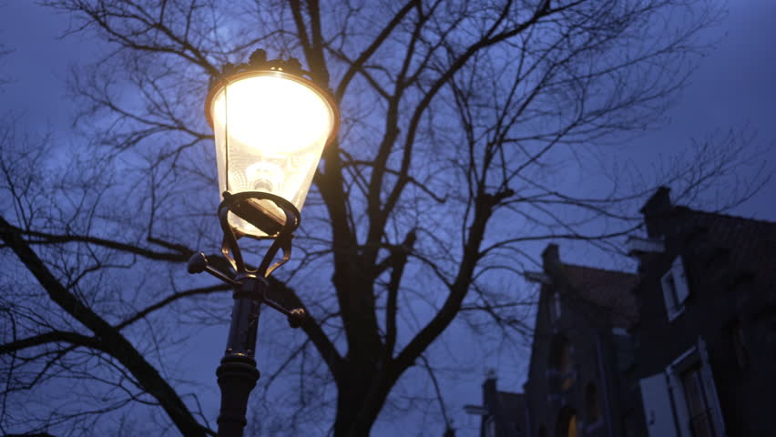 Illuminated street of amsterdam. Close-up view vintage lantern