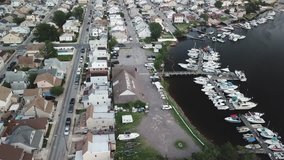 Aerial drone footage video from Gerritsen Beach and Shell Bank Creek wlth houses yachts boats. Brooklyn New York