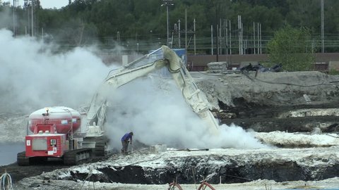 OSTRAVA, CZECH REPUBLIC, AUGUST 28, 2018: Liquidation of remediation of landfills waste of oil and toxic substances, burnt lime is applied to the oil pollution by means of a fine cutter excavator