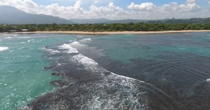 Tropical paradise pacific atoll islands. Top view. Aerial drone bird's eye view video on sea waves and rocks, turquoise water. Shot in 4k
