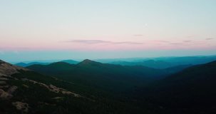 Aerial drone footage of beautiful sunset in Carpathian mountains.Sun goes down over mountain horizon in national park.Travel destination for active tourism in Europe