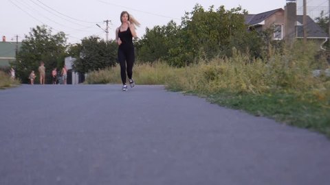 Beutiful girl running at sunset. Outdoor sports.