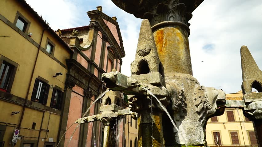 Details of the Grande Fontana in stone with lion-shaped decorations, in a public square in Viterbo