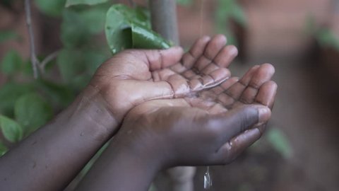 Water pouring into the hands of an African child just outside Bamako, Mali. Water scarcity will represent a huge problem in the future, especially for developing countries.