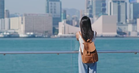 Woman look at the view of kowloon  in Hong Kong