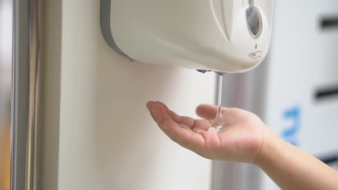 child or kid wash hands by hand wash gel machine or sanitizer for clean and healthy with kill bacteria or antibacterial at department store or school and restaurant on slow
