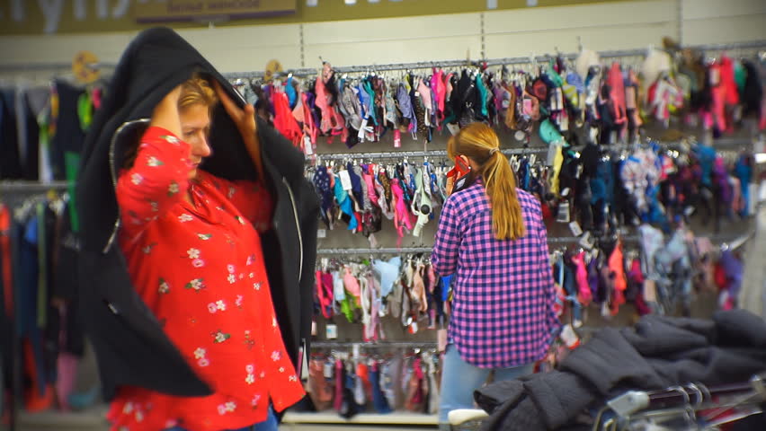 Woman in a big store trying on clothes