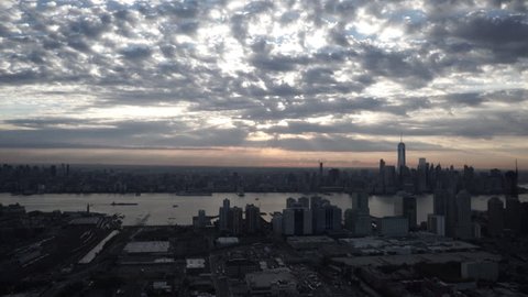 New York City Circa-2015, wide angle aerial view of the Manhattan skyline from Jersey City, with sunbeams shining through the clouds