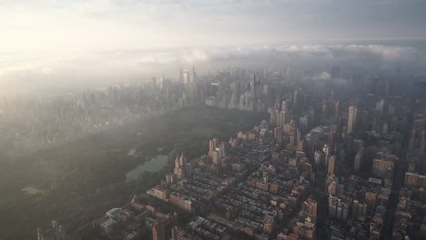 New York City Circa-2015, aerial view of Manhattan from the Upper West Side and Central Park at sunrise, with fog and low level clouds over Midtown