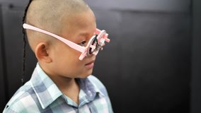 eyesight check. Asian boys who have vision disabilities. Left eye is not visible from brain surgery. Medical treatment and Rehabilitation. video 4k
