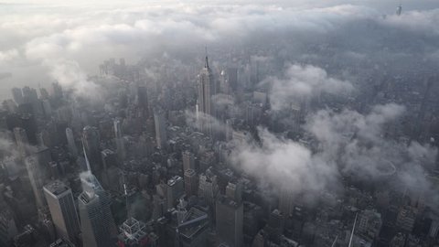 New York City Circa-2015, aerial view of from Midtown Manhattan looking south, with low level clouds at sunrise